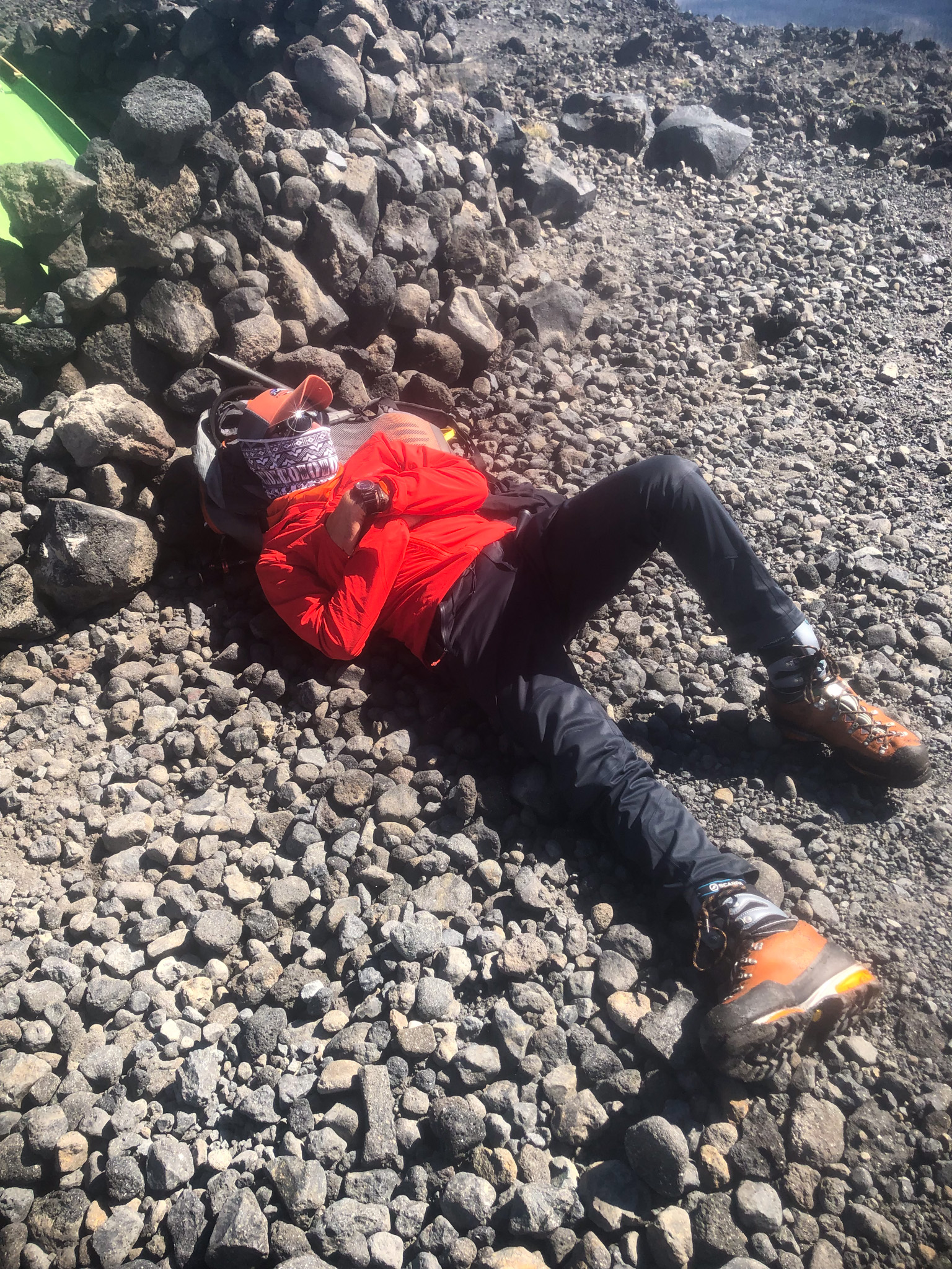 Exhausted athlete resting on mountain