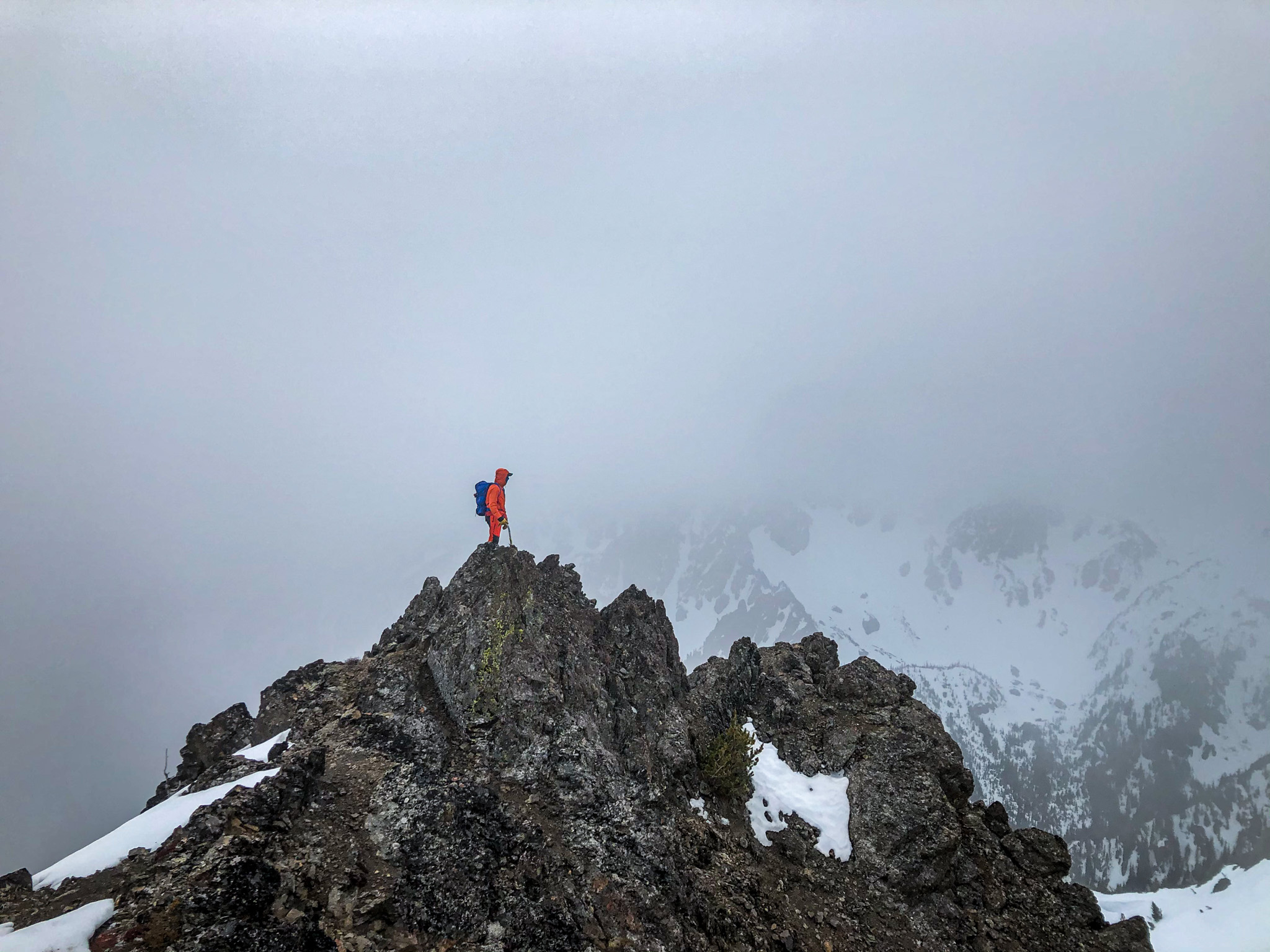 Lone mountaineer on misty summit