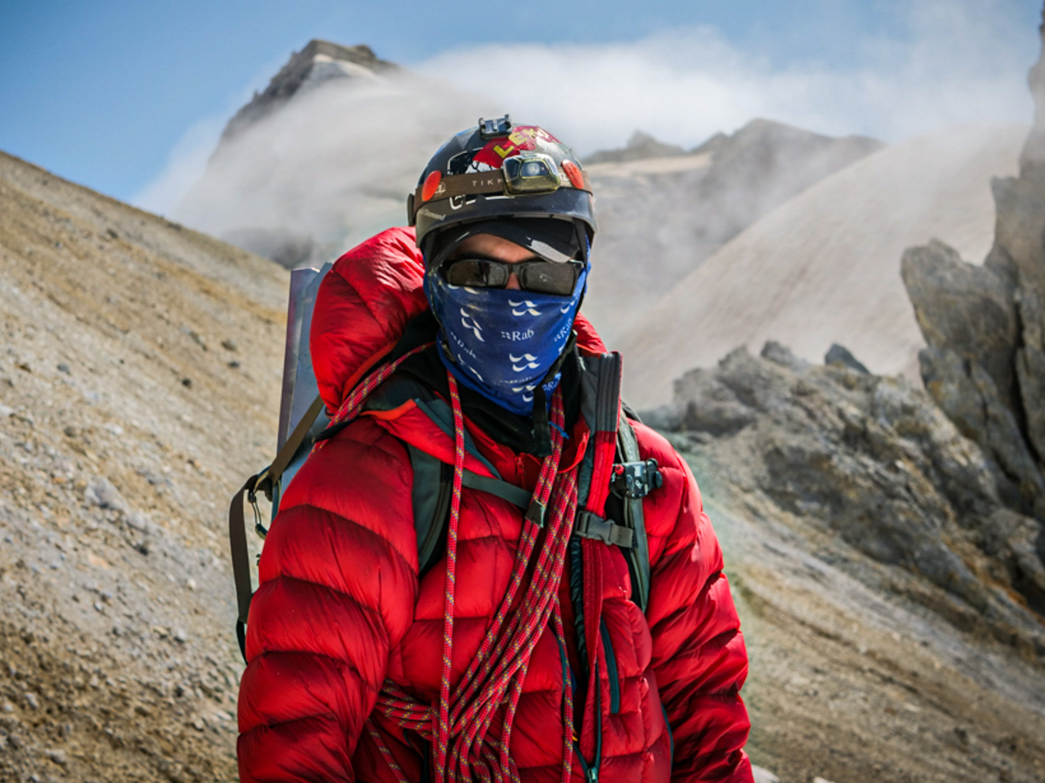Mountaineer with rope on alpine ridge
