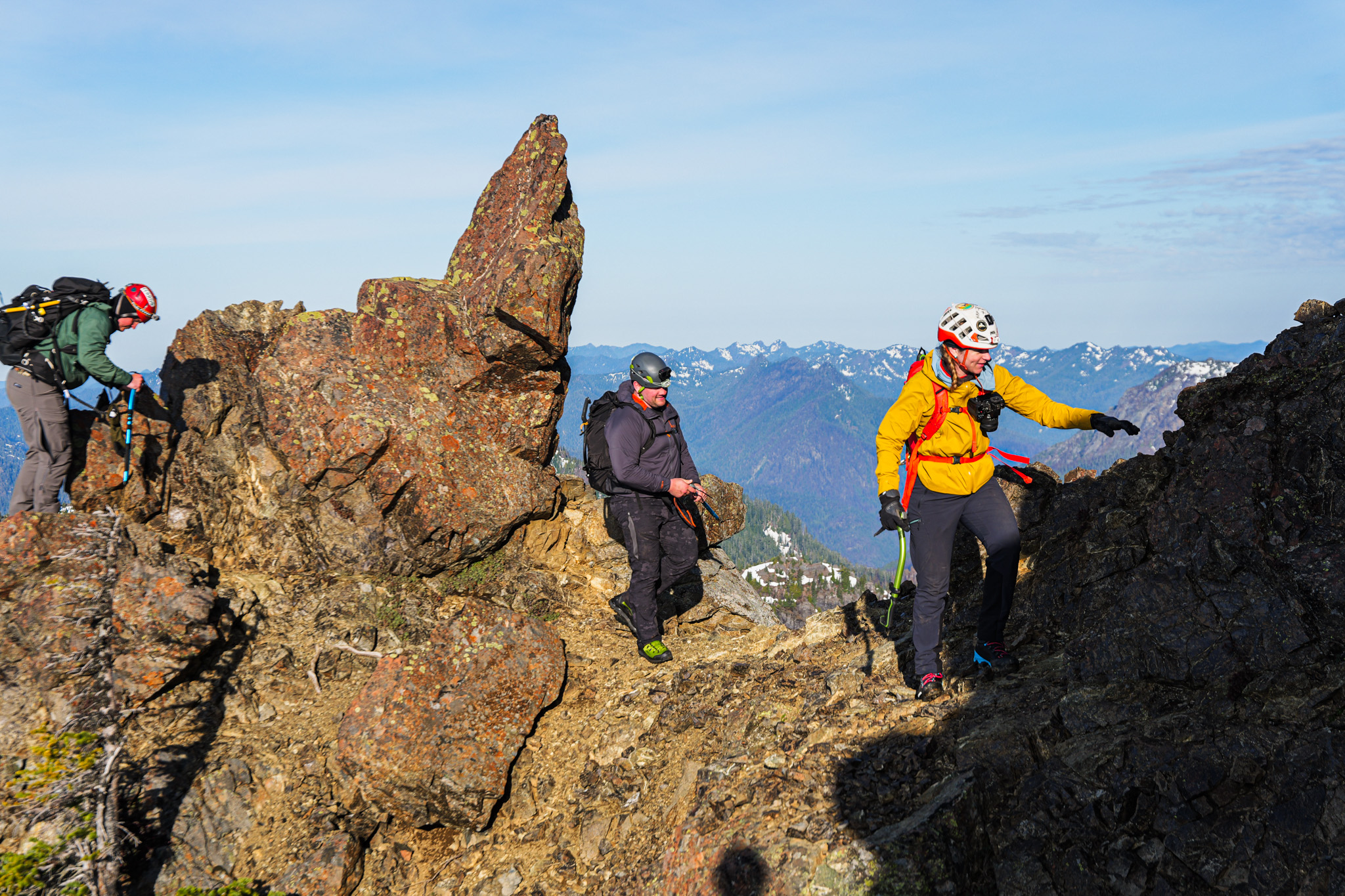 Team traversing rocky ridge