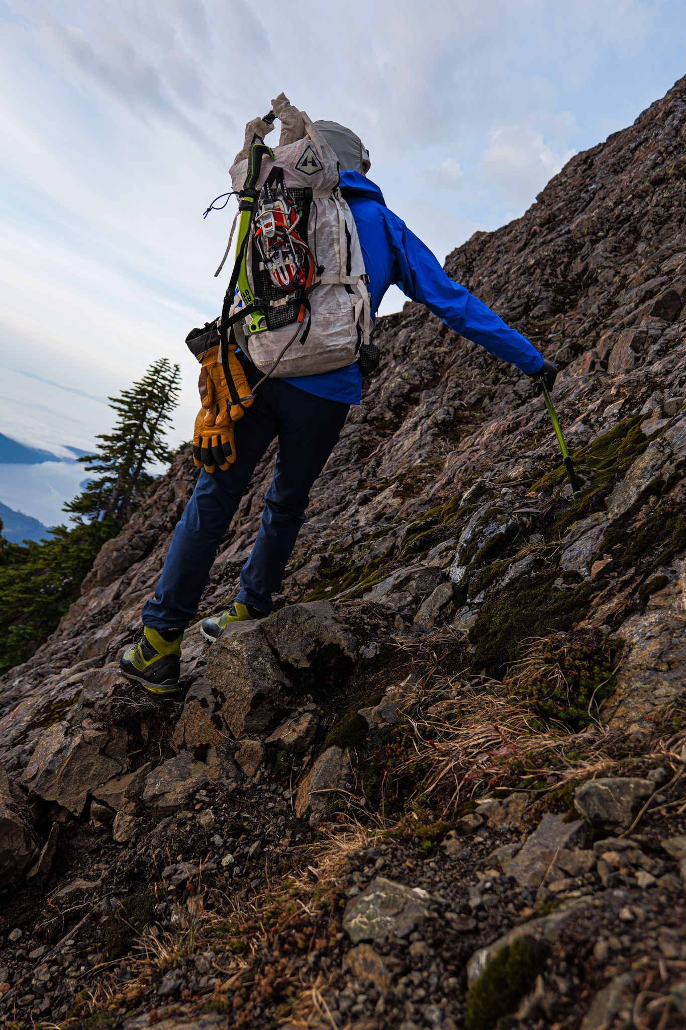Climber ascending rocky slope